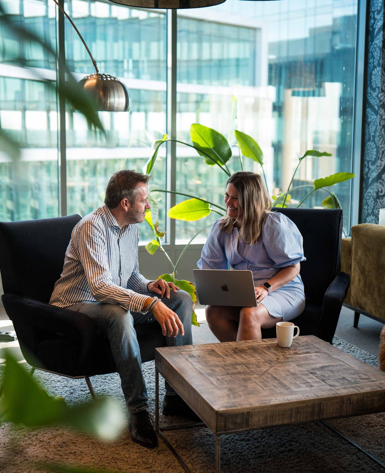 Two colleagues in conversation in a lounge area